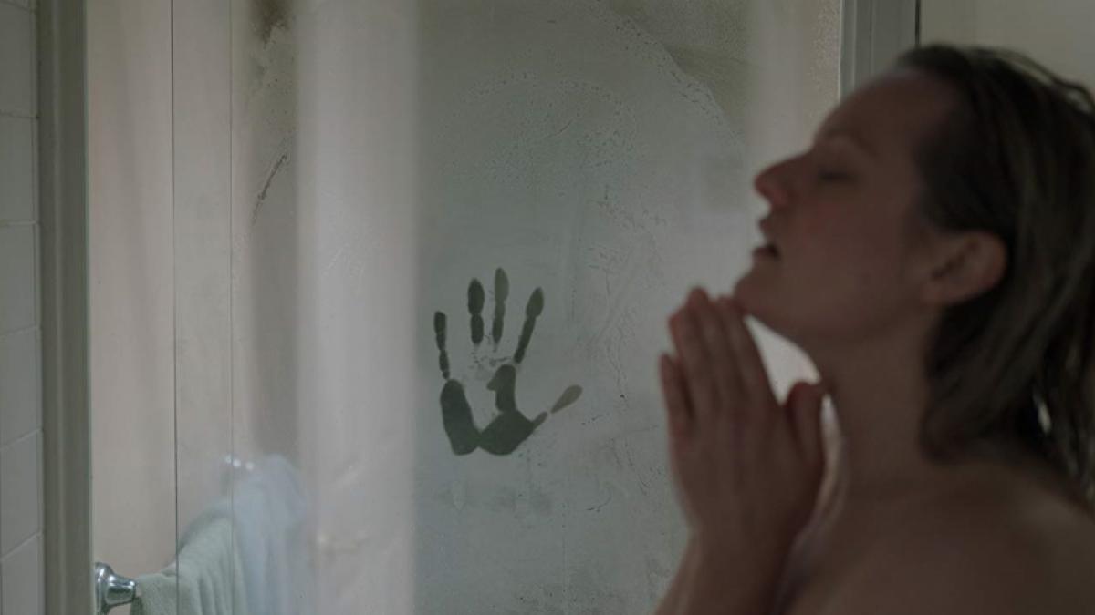 Cecilia Kass (Elizabeth Moss) showers, unaware of the ghostly handprint on the glass shower door, in Leigh Whannell's 'The Invisible Man'.