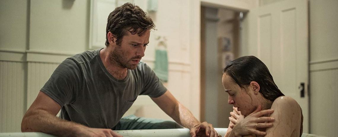 Will (Armie Hammer) and Carrie (Dakota Johnson) are plagued by dark visions in Babak Anvari's Wounds. 