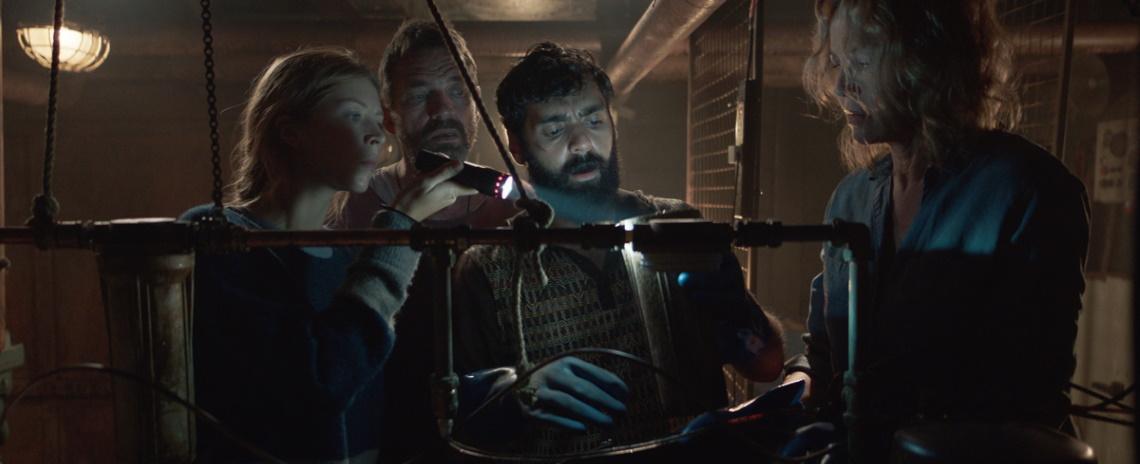 A marooned trawler's crew (left to right: Hermione Corfield, Dougray Scott, Ardalan Esmaili, and Connie Nielsen) contend with a parasite in their water supply in Neasa Hardiman's 'Sea Fever'. 